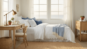 Cozy coastal-themed dorm room with a lofted bed, honey-toned desk, seashell wallpaper, and warm ambient lighting, featuring soft blues, whites, and sandy beiges.