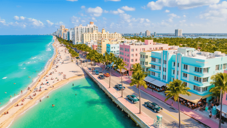 Why South Beach in February is Your Ultimate Winter Escape (Without the Winter Chill!) "Aerial view of South Beach Miami with Art Deco buildings, turquoise waters, white sandy beaches, and people enjoying the outdoor lifestyle under the golden afternoon light."